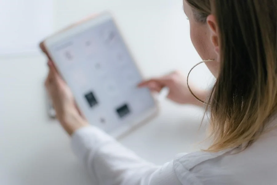 A female professional browsing the internet to find management software for contests capable of handling different types of competitions